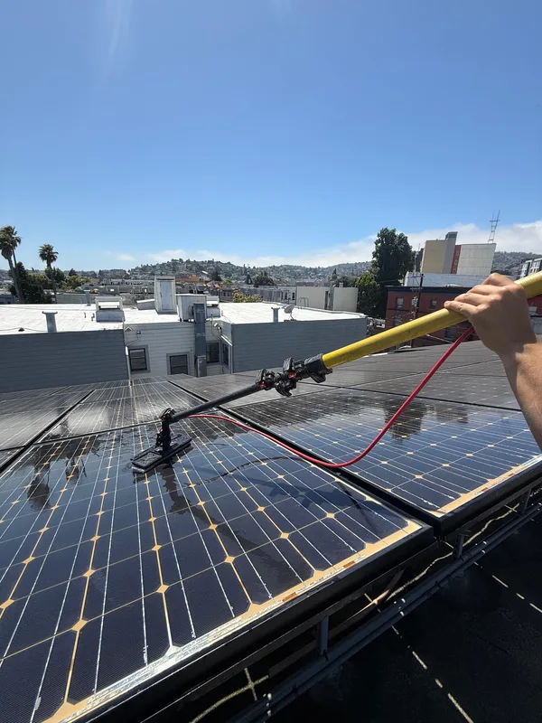 Solar Panel Sparkle cleaning technician scrubbing solar panels professionally